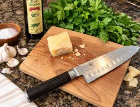 maple cutting board with knife on kitchen counter